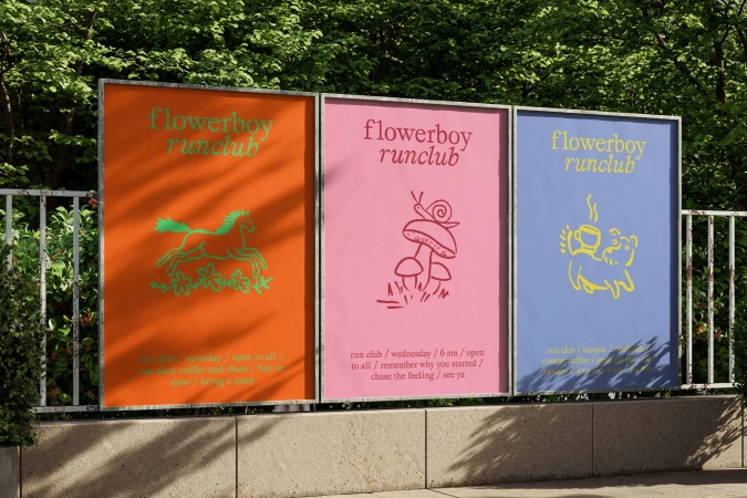 Three colourful 'flowerboy runclub' poster designs displayed outdoors, featuring unique illustrations and event information.