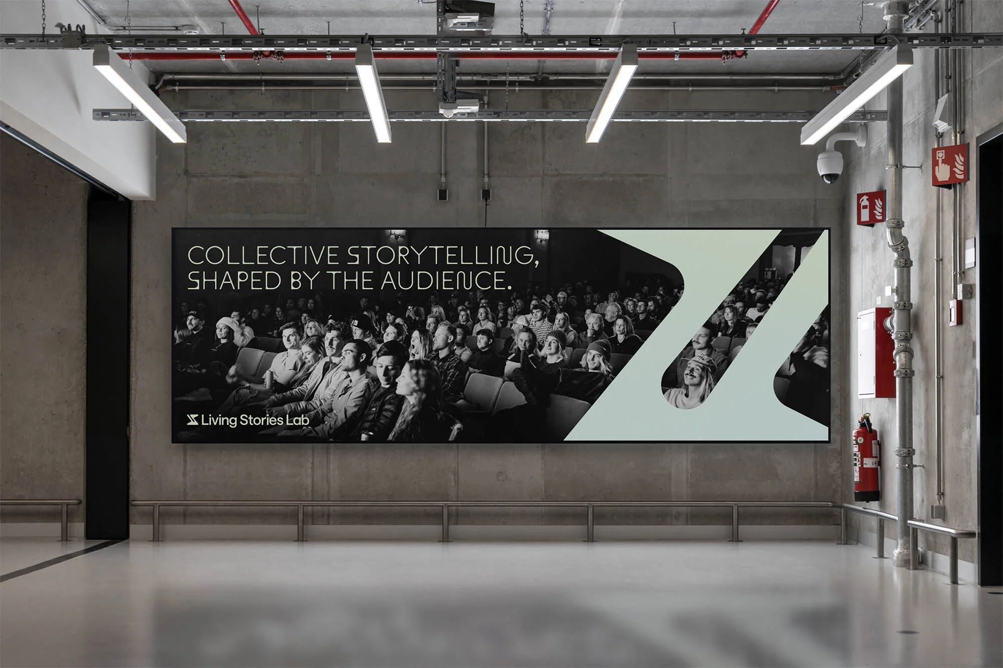 Indoor view of a poster featuring a crowd, with the text 'Collective Storytelling, Shaped by the Audience' and Living Stories Lab logo.