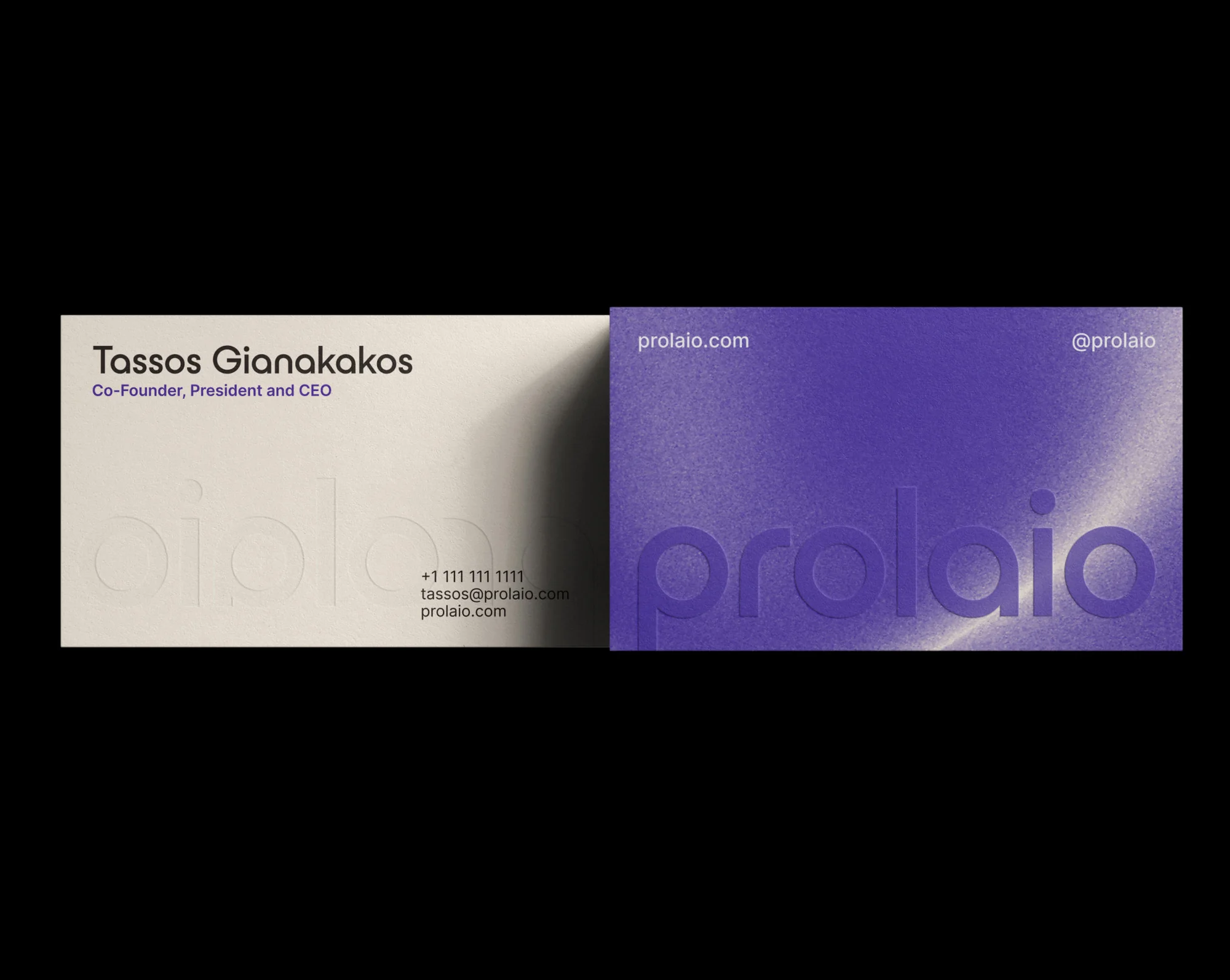 Two business cards, one light beige with black text and one purple business card with white and purple text on a black background.