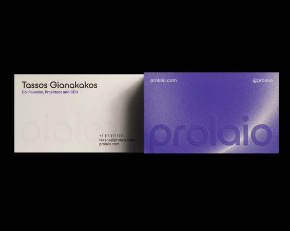Two business cards, one light beige with black text and one purple business card with white and purple text on a black background.