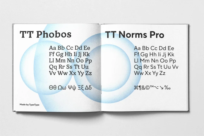 An open typography booklet showcasing typeface samples with blue gradient graphic circles on the pages.