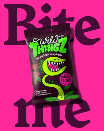 A bag of Wild Thingz candy on a hot-pink backdrop features a cartoon plant, playfully inviting 'Bite me' in a whimsical layout.