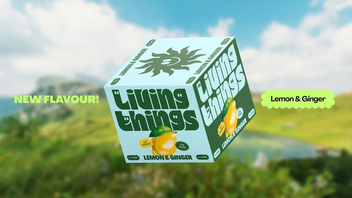 A light-blue cube of Living Things lemon & ginger beverage floats outdoors, surrounded by mountain scenery. Text reads, "New Flavour!"