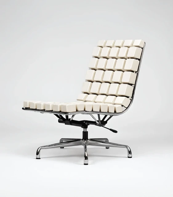 Office chair with a chrome frame and swivel base. The seat and backrest are covered in white keyboard keycaps. Plain white background.