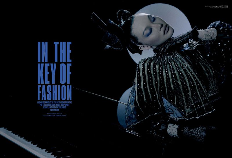 Fashion editorial featuring a poised woman in ornate dark attire, juxtaposed against a piano and circular backdrop in a studio setting.