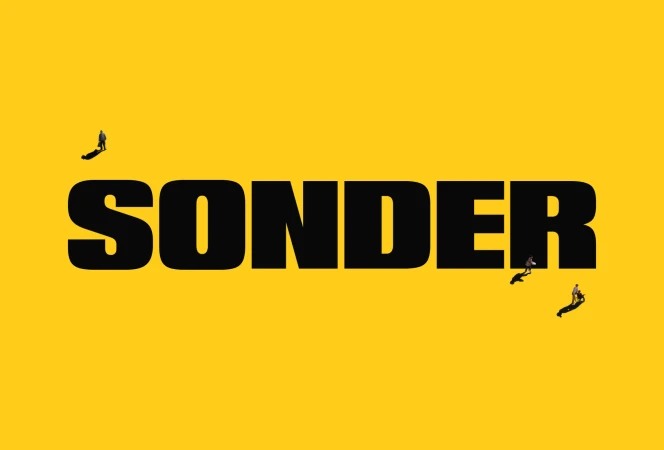 Typographic art with 'SONDER' in bold black letters against yellow. Three small figures add depth, walking along the text.