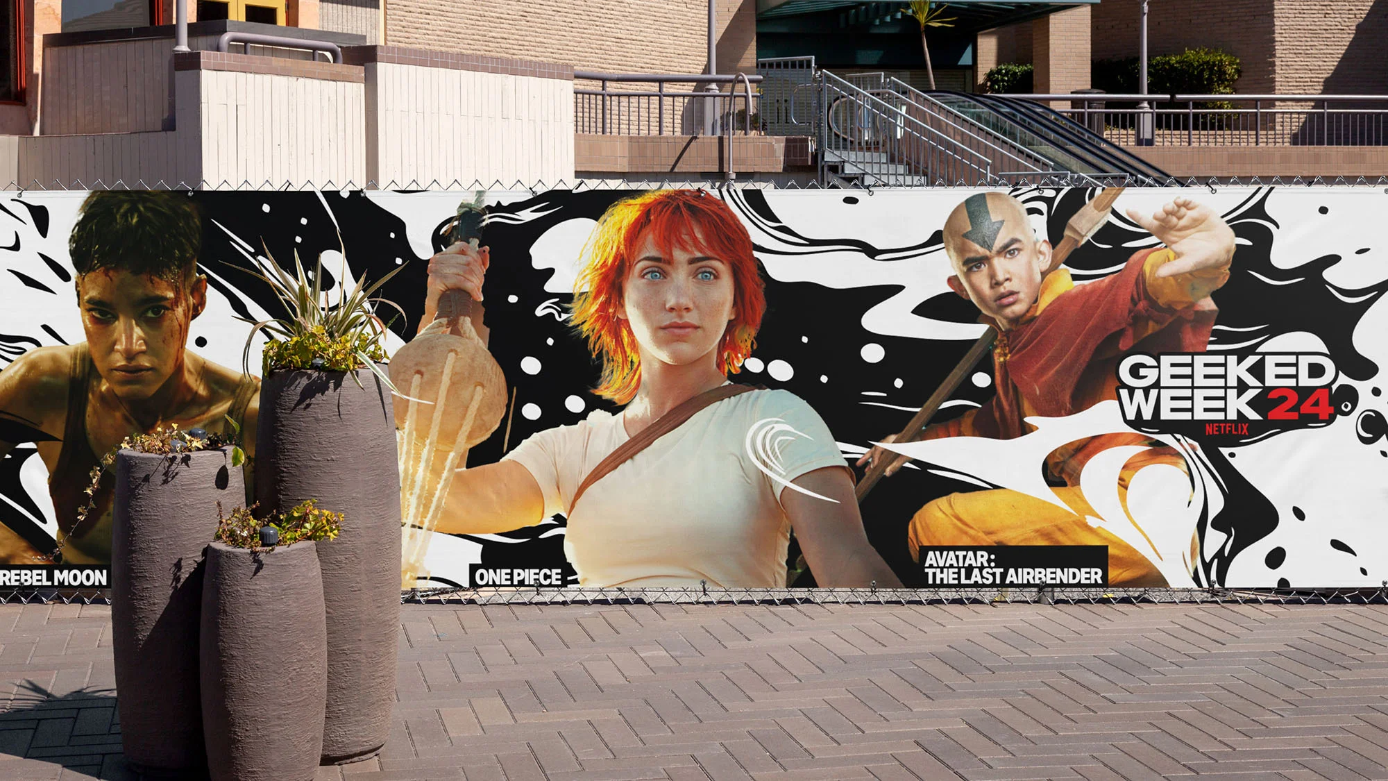 Outdoor banner advertising Netflix Geeked Week 24, featuring Rebel Moon, One Piece, and Avatar: The Last Airbender characters.