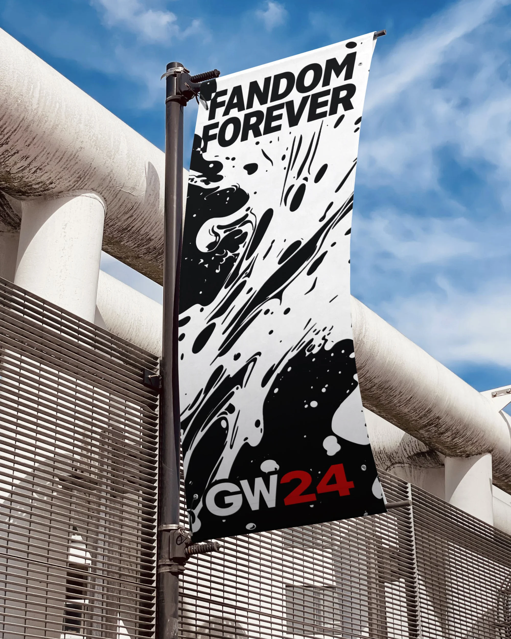 Banner with 'FANDOM FOREVER' and black paint splatter on a metal pole against a gray metal and white pipe background.