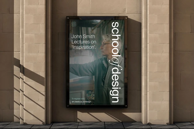 Poster on a brick wall promotes a John Smith lecture on 'Inspiration' at the School of Design, with the lecture details and a website listed.