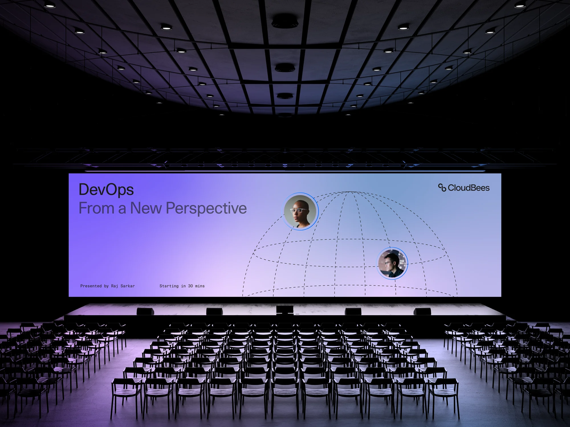 An auditorium features rows of empty chairs facing a stage with a large screen displaying 'DevOps: From a New Perspective' and CloudBees logo.