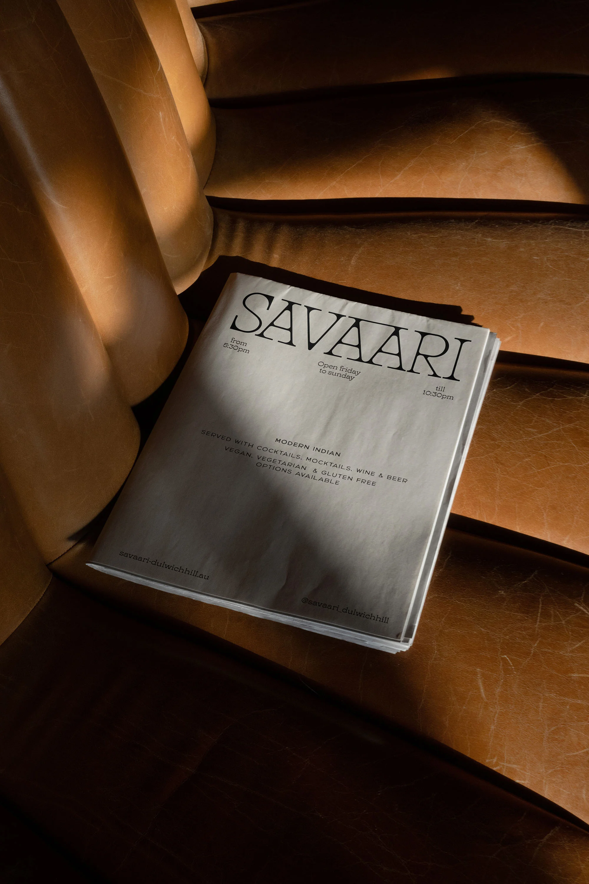 Magazine titled 'Savaari' resting on an amber chair. The magazine cover is white with bold, dark lettering.