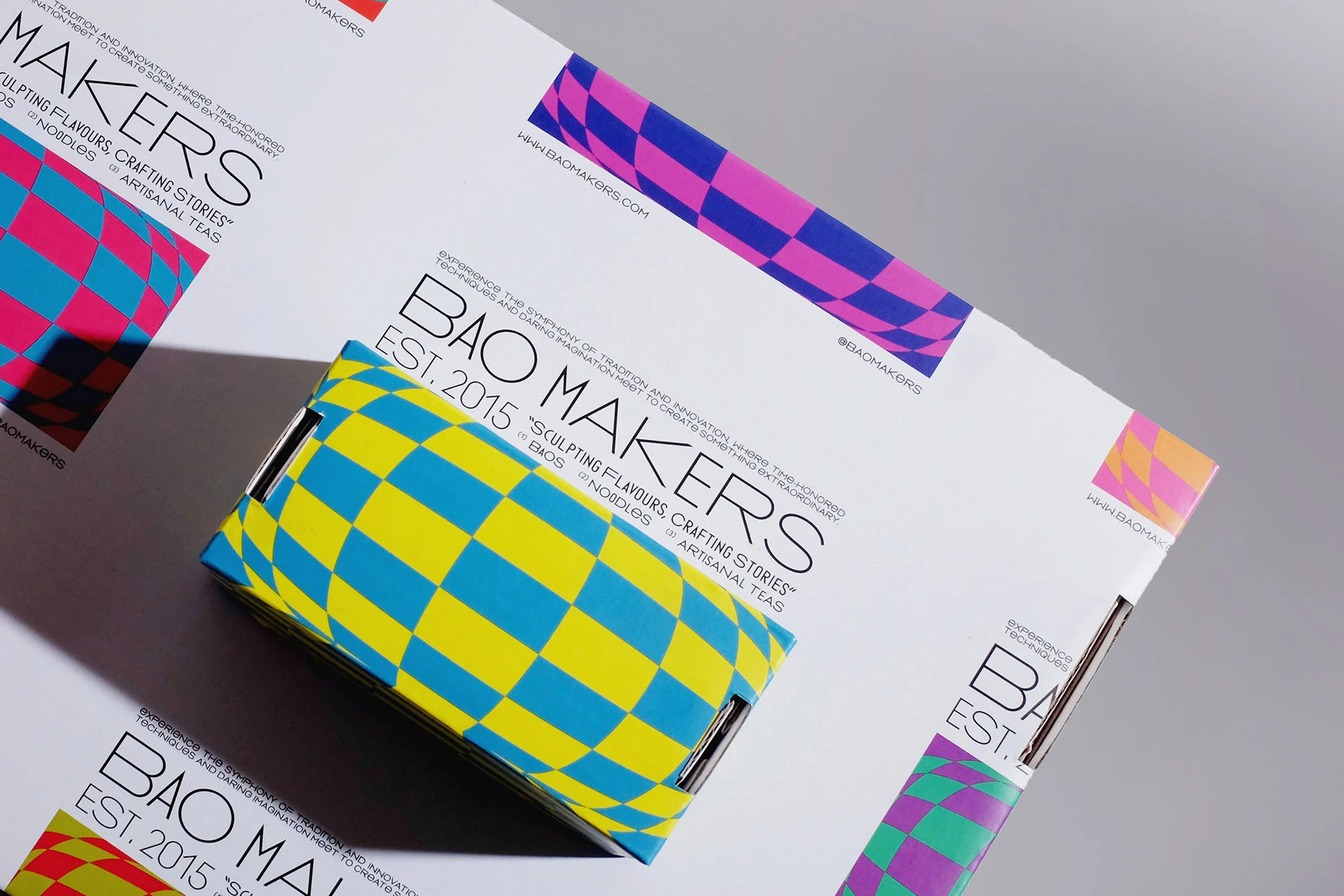 Product packaging featuring blue and yellow checkerboard pattern, on a white surface with company branding and marketing copy.