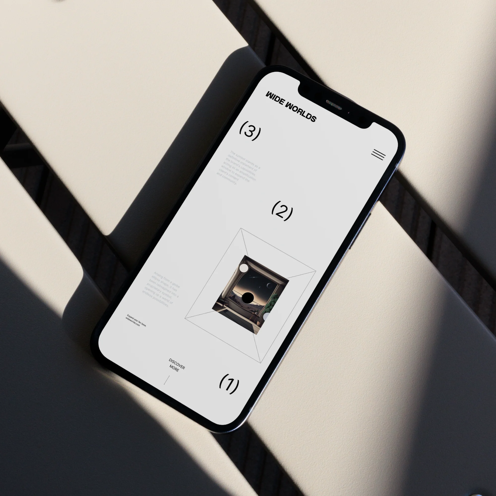 Smartphone displays website design, featuring geometric shapes, monochrome palette, and sans-serif typography on a bright white background.