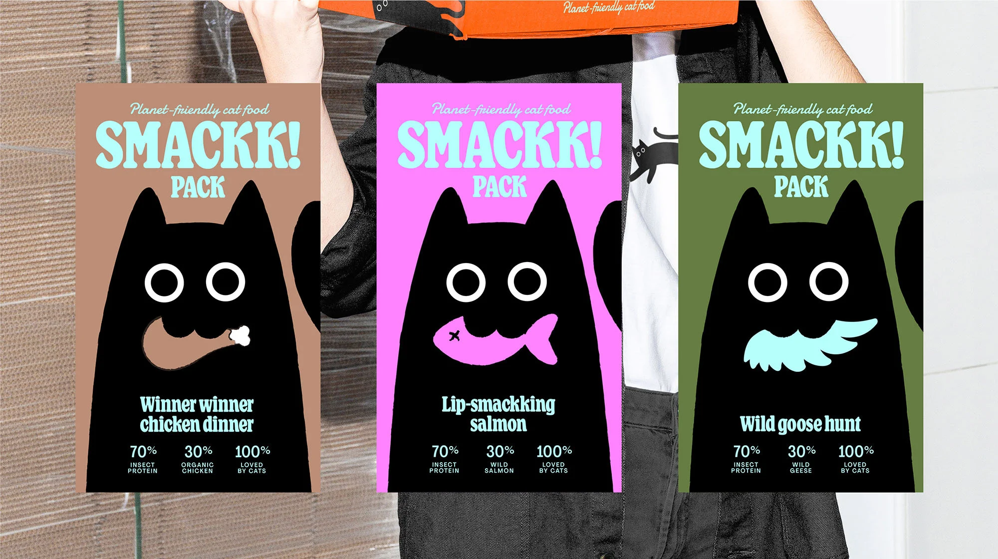 Three packages of Smackk! planet-friendly cat food: Winner Winner Chicken Dinner, Lip-Smackking Salmon, and Wild Goose Hunt.