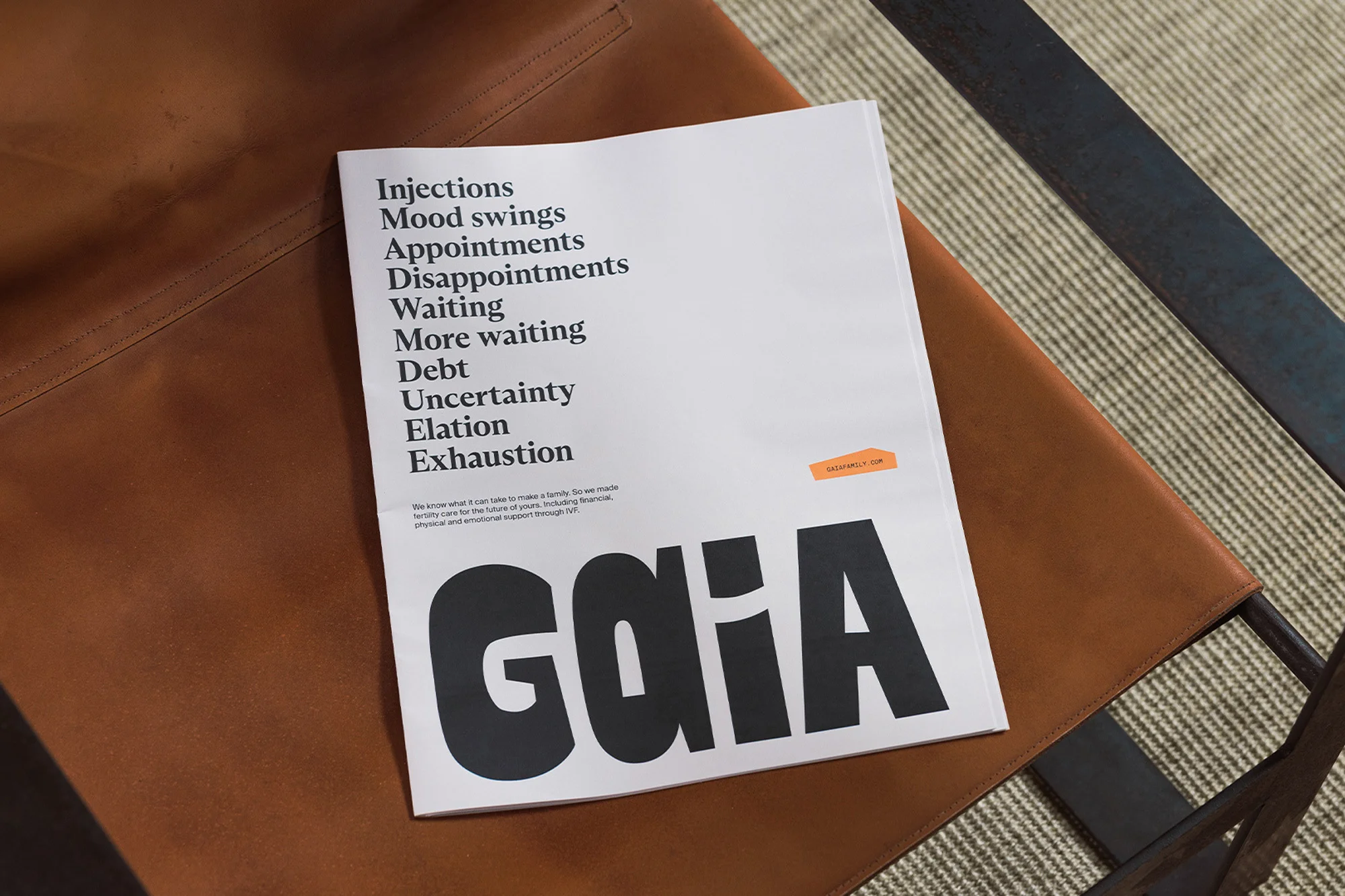 An eye-level, close-up shot features a 'GAIA' magazine centered on a tan leather chair, exhibiting its cover design and textual content.