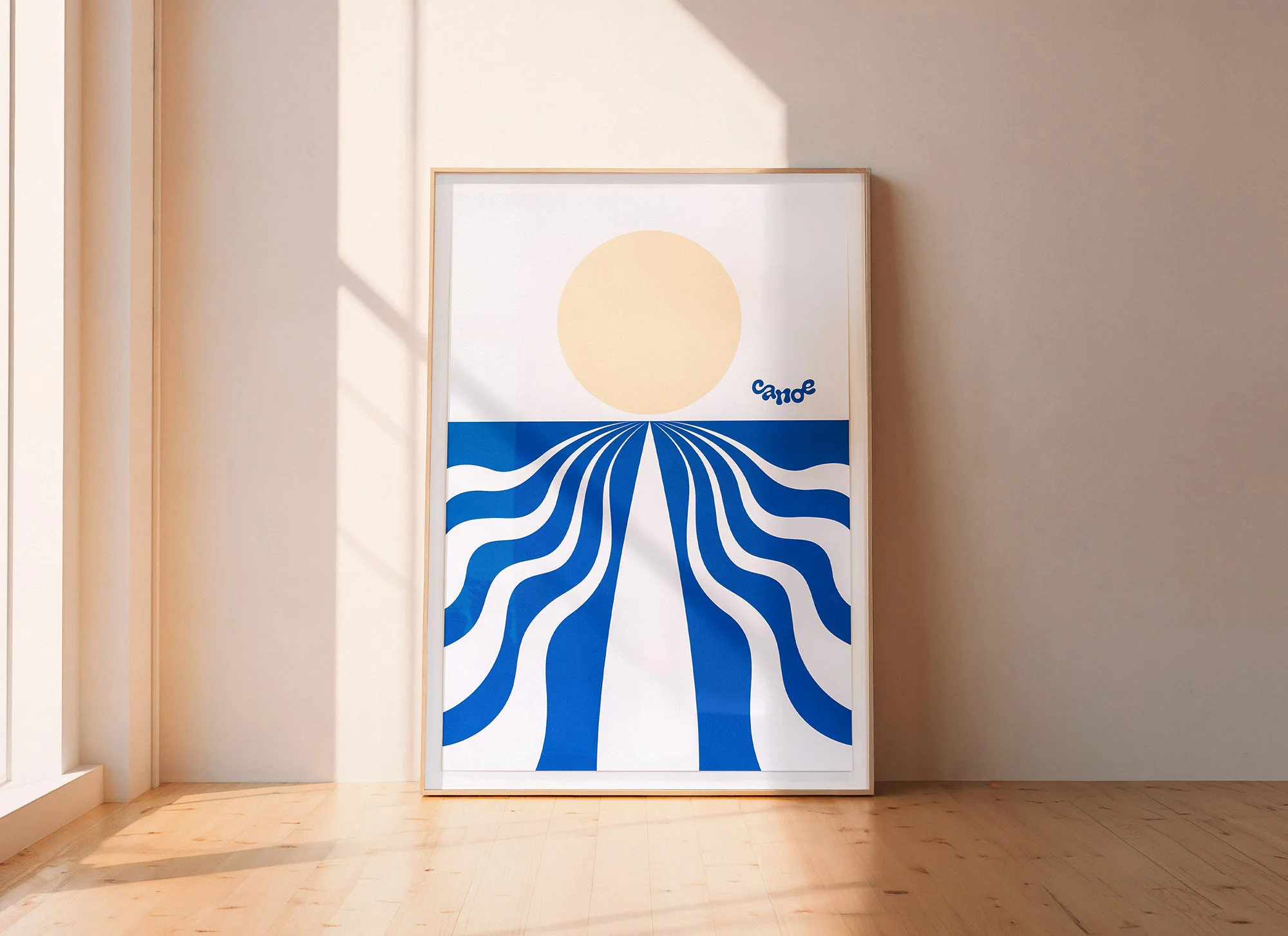 Framed graphic art print features blue and white wavy lines converging below a yellow sun, displayed in minimalist room setting.