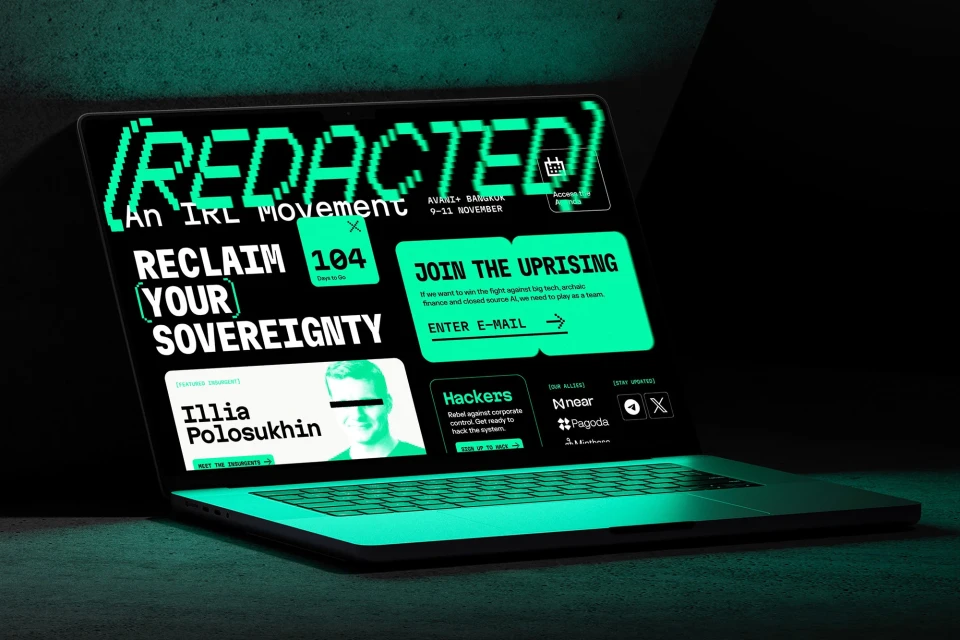 Laptop displaying 'REDACTED: An IRL Movement,' featuring digital event info, portraits, and registration prompts, all in green on black.