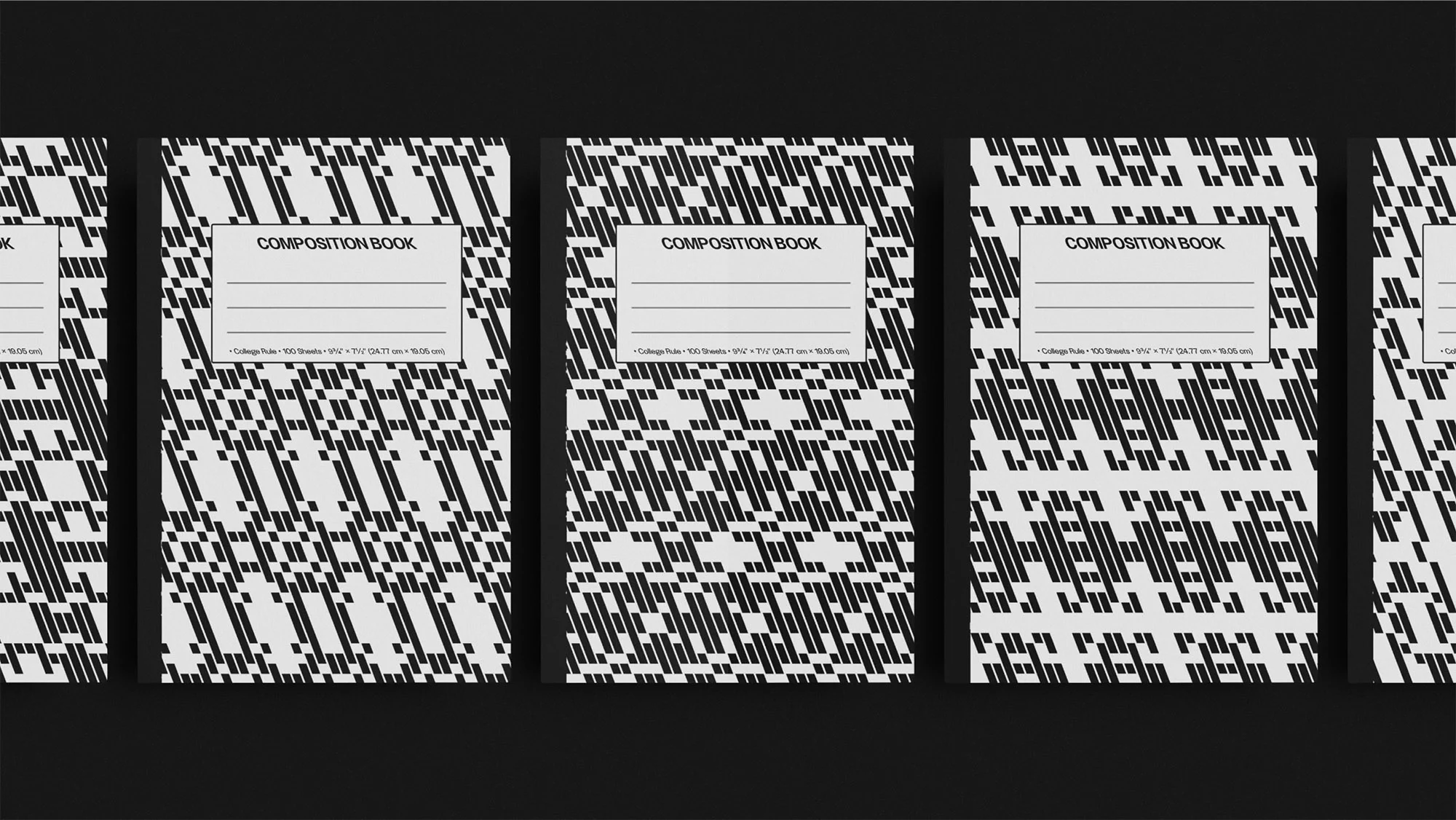 Multiple composition books with a black and white geometric pattern. The books are lined up in a row on a flat, dark surface.