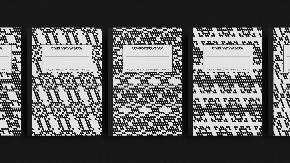 Multiple composition books with a black and white geometric pattern. The books are lined up in a row on a flat, dark surface.
