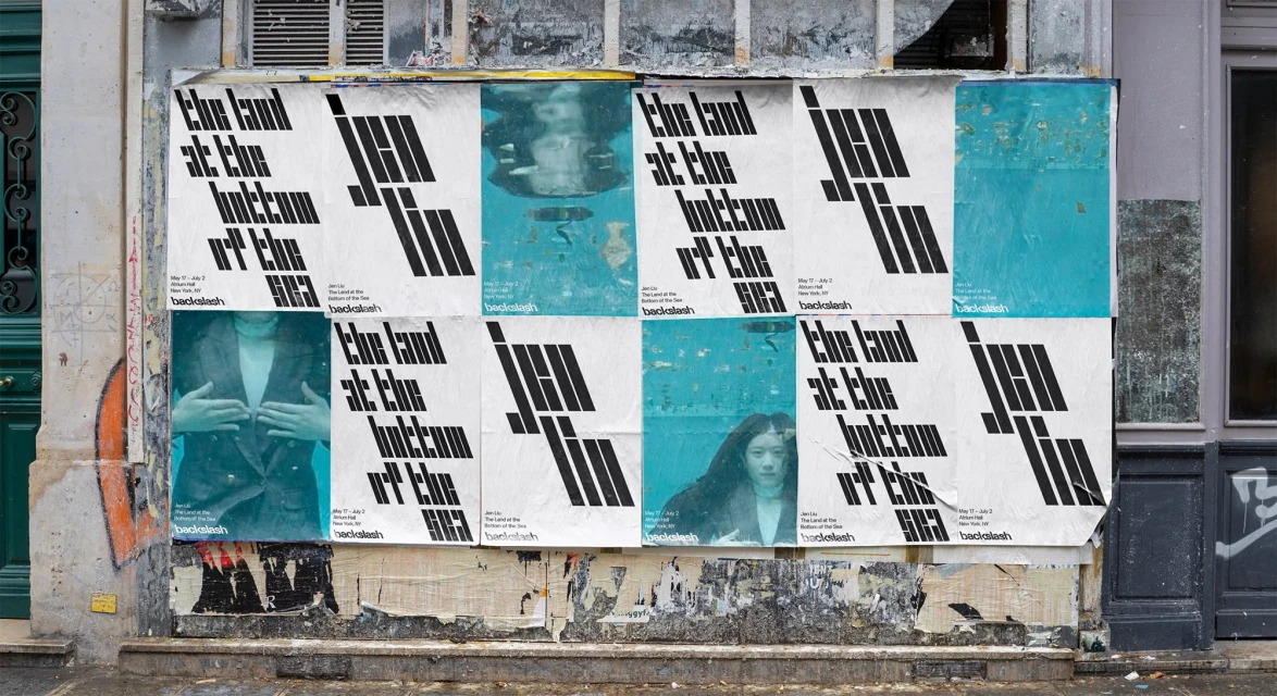 Outdoor posters on a building feature typography and portrait art, mounted to textured walls in an urban environment, daylight.