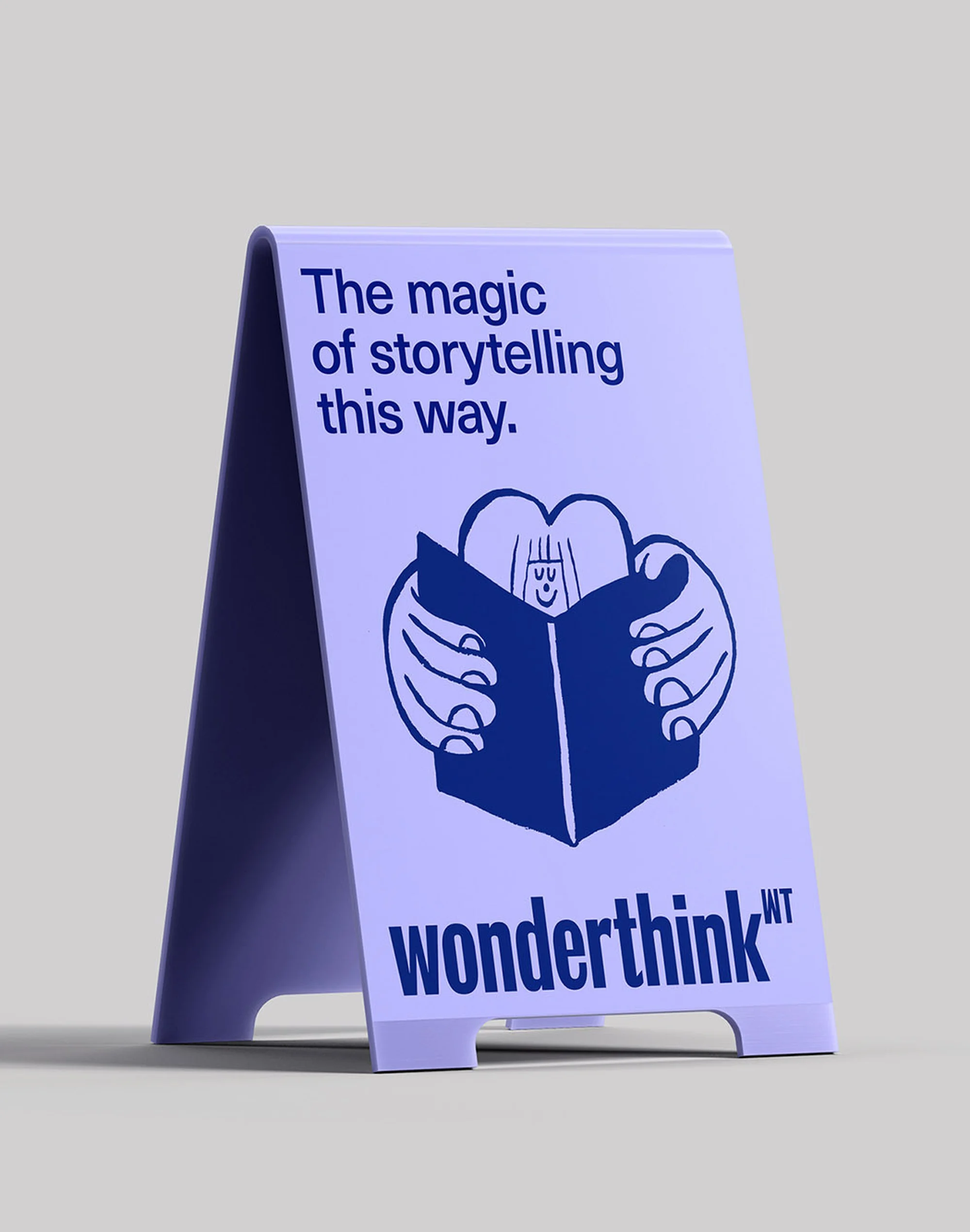 Illustration of an A-frame sign with the words 'The magic of storytelling this way' with a cute character reading a book.