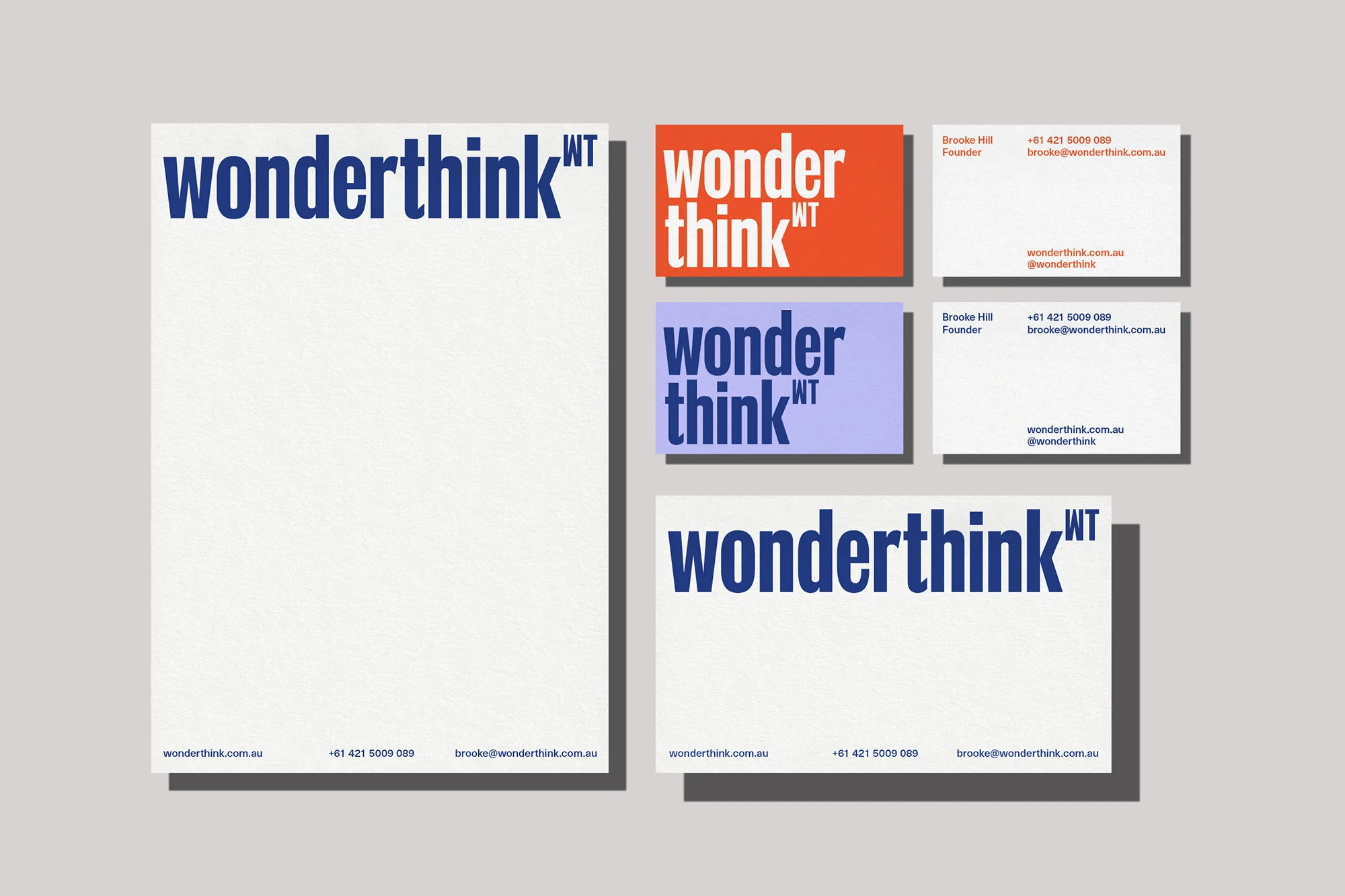 Branding mockup featuring letterhead, business cards, and stationery with the word 'wonderthink' in blue against a light gray backdrop.