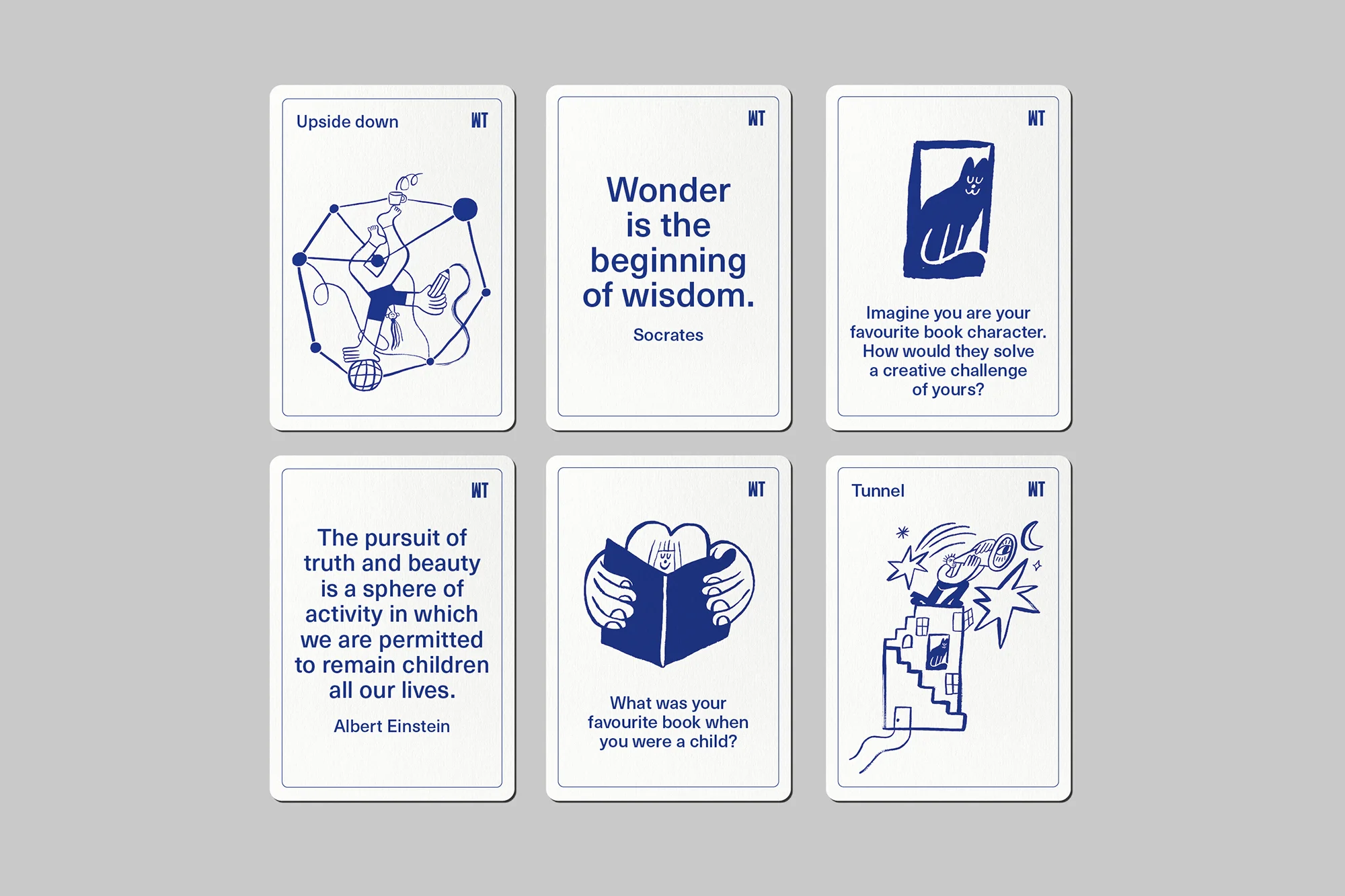 Six white cards with blue graphic designs and text are arranged on a neutral background, possibly a set of creative prompts.