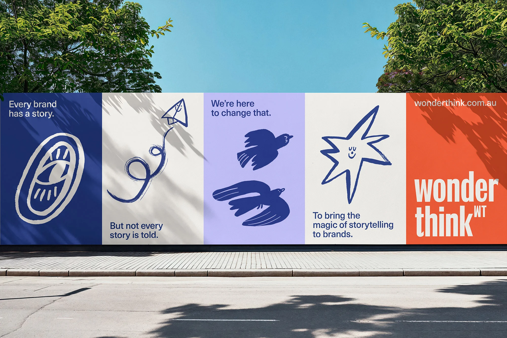 Outdoor advertising billboard featuring illustrations and marketing copy for Wonderthink, set against a bright sky and tree foliage.