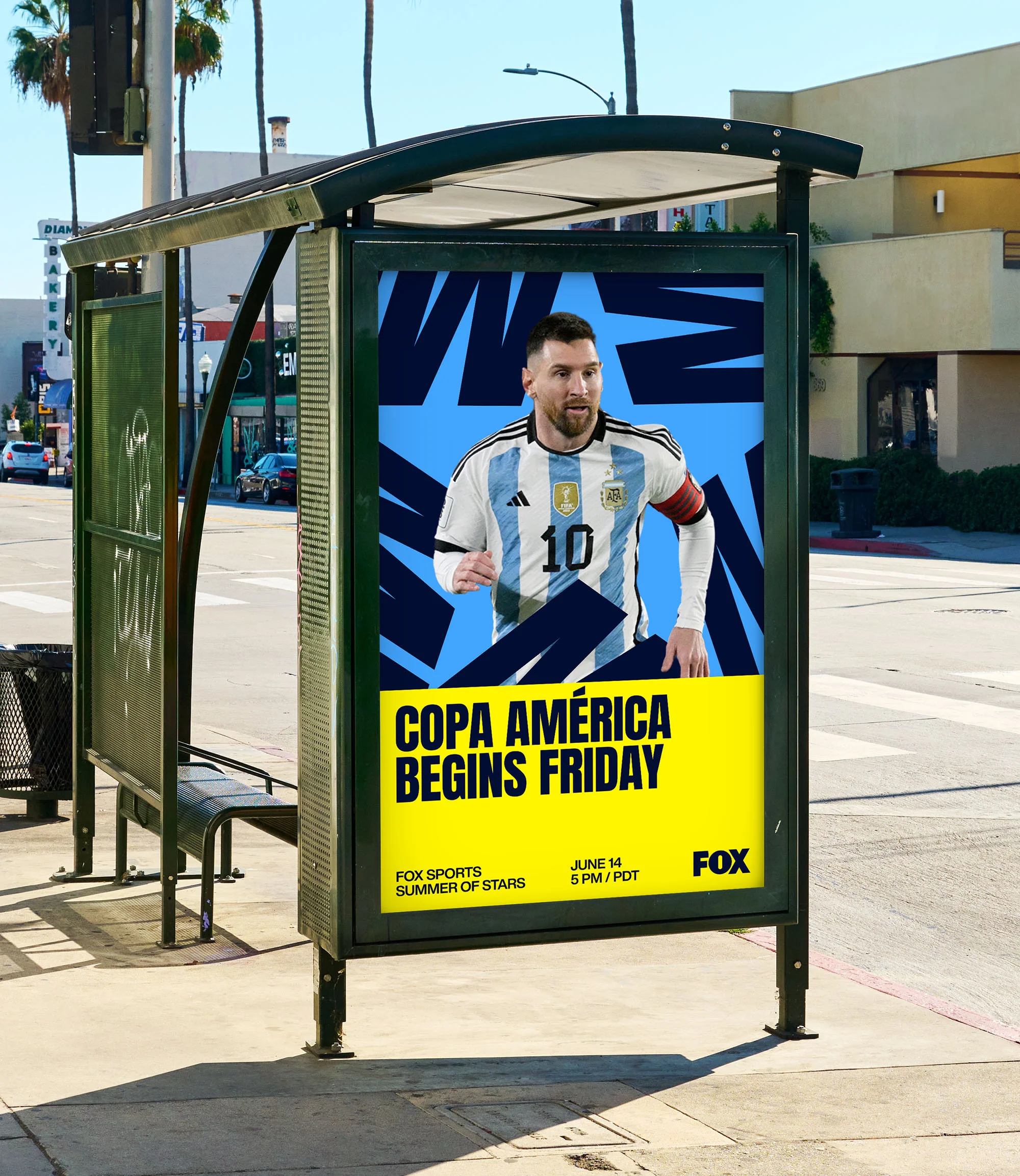 Outdoor advertising billboard on a city street features soccer star Lionel Messi for the Copa América tournament promotion.
