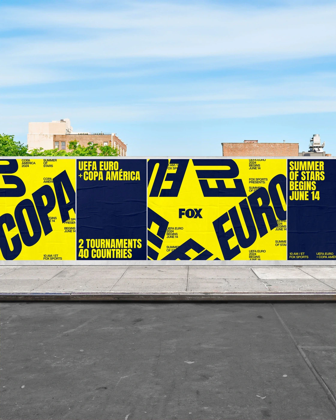 Outdoor city wall plastered with vibrant yellow and dark blue posters displaying bold typographic tournament branding.