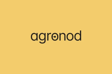 Agronod brand identity logo featuring dark lowercase typography set against a solid mustard yellow background.