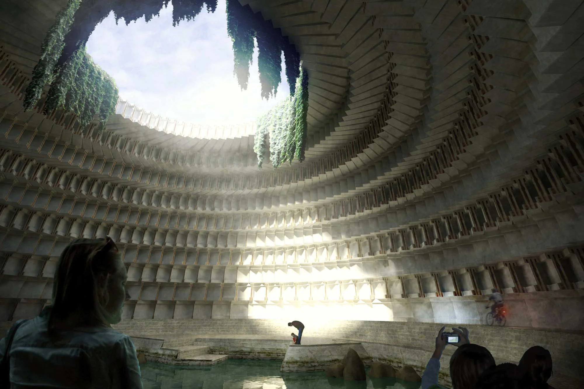 People inside an ancient, circular, stone water reservoir with tiered seating, hanging vines, and light streaming through the open top.