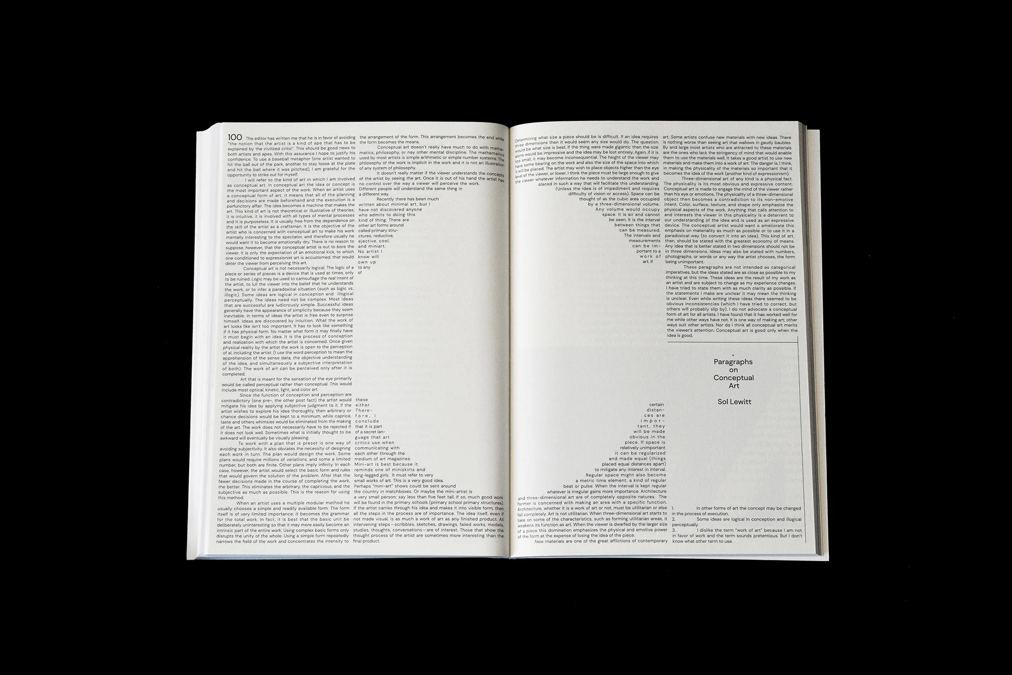 Open book with a text-based art piece in the center, featuring the words 'Paragraphs on Conceptual Art' by Sol LeWitt.