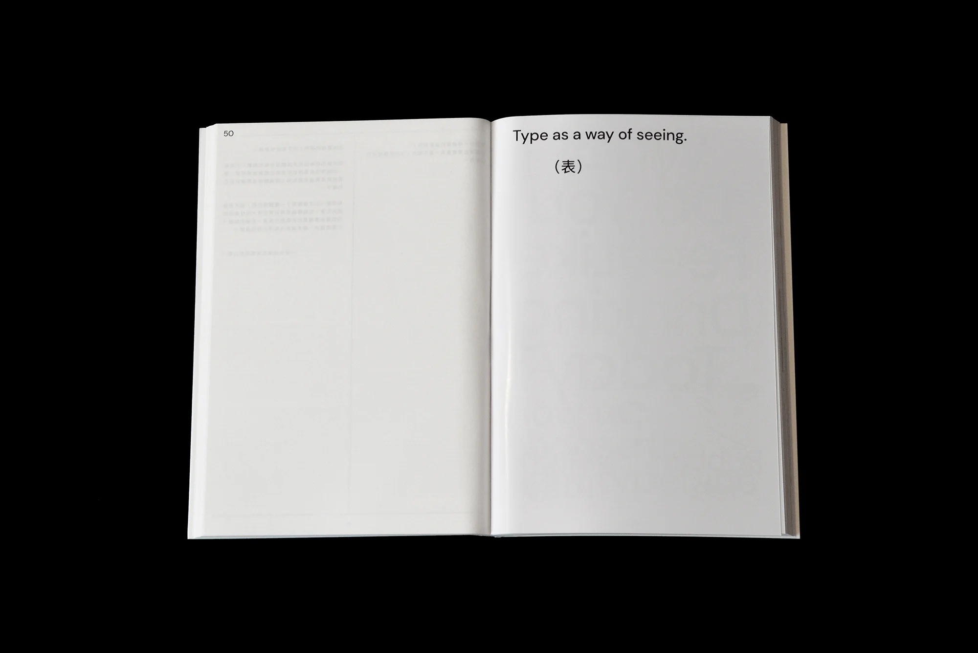 Open book featuring the phrase 'Type as a way of seeing' in black text against a white page, set against a solid black background.