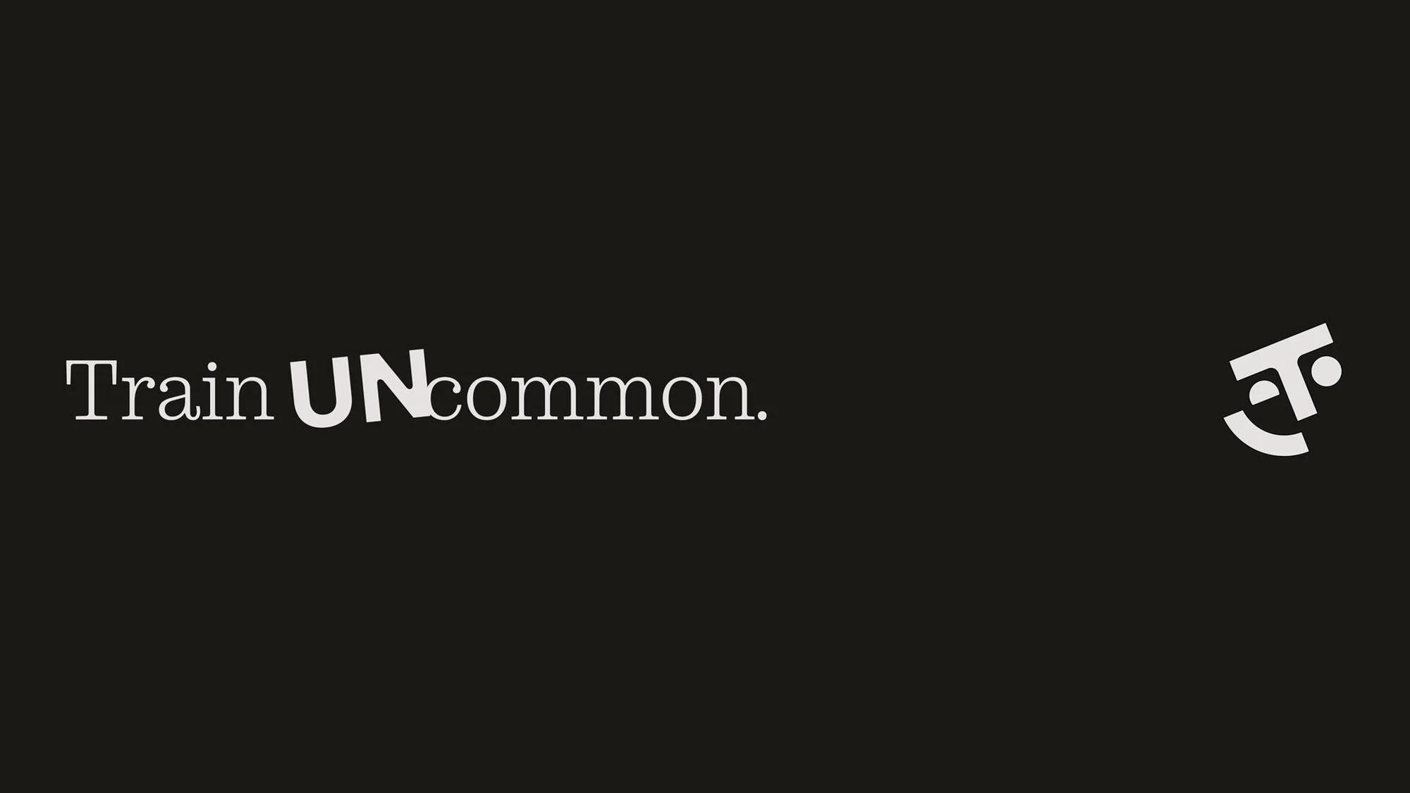 Promotional image with the text 'Train UNcommon' in a sans-serif typeface and a stylized geometric logo on a dark background.