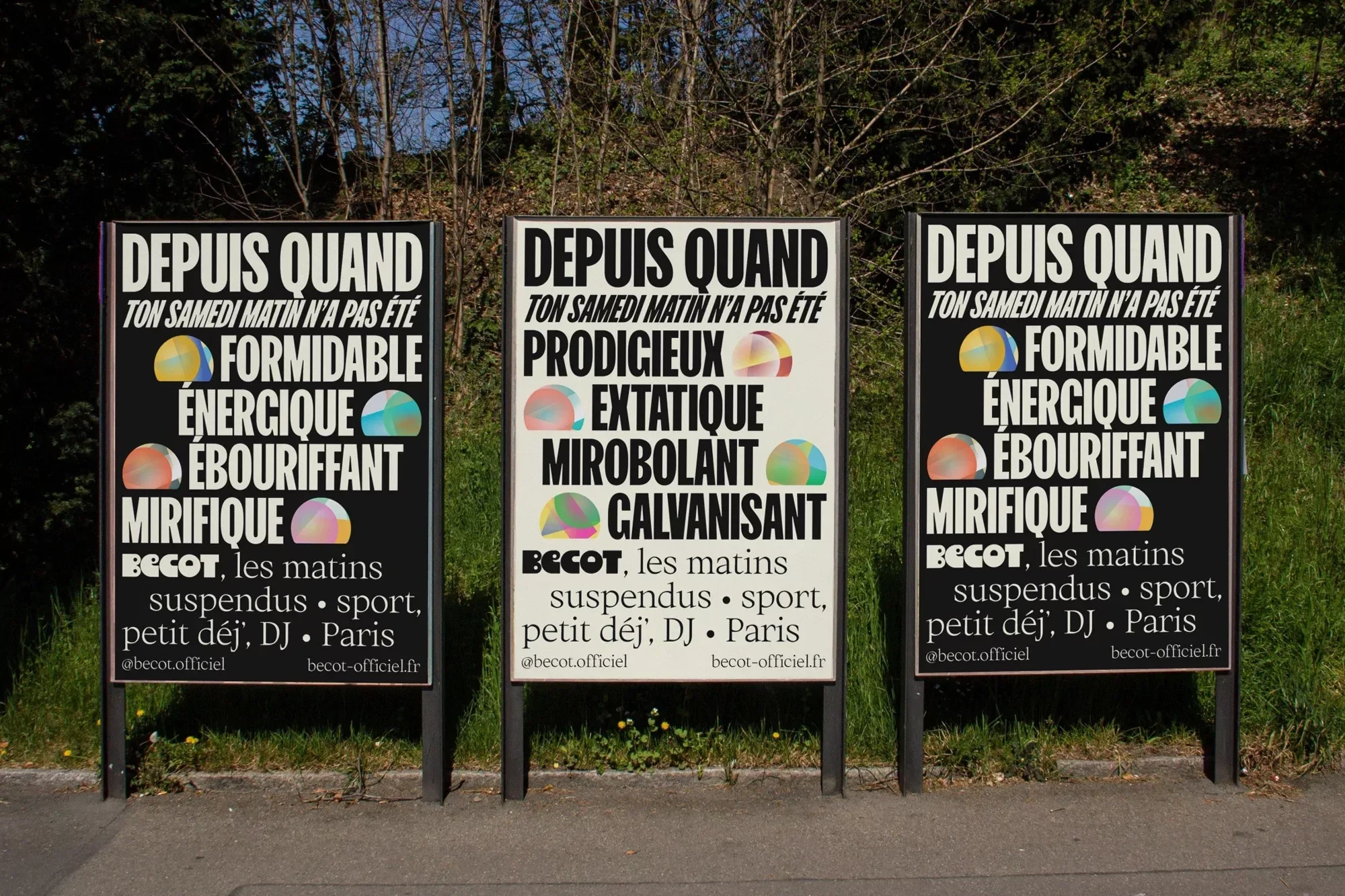 Three colorful posters that read “Depuis Quand” stand side by side in an outdoor setting with a lush green backdrop and pathway.