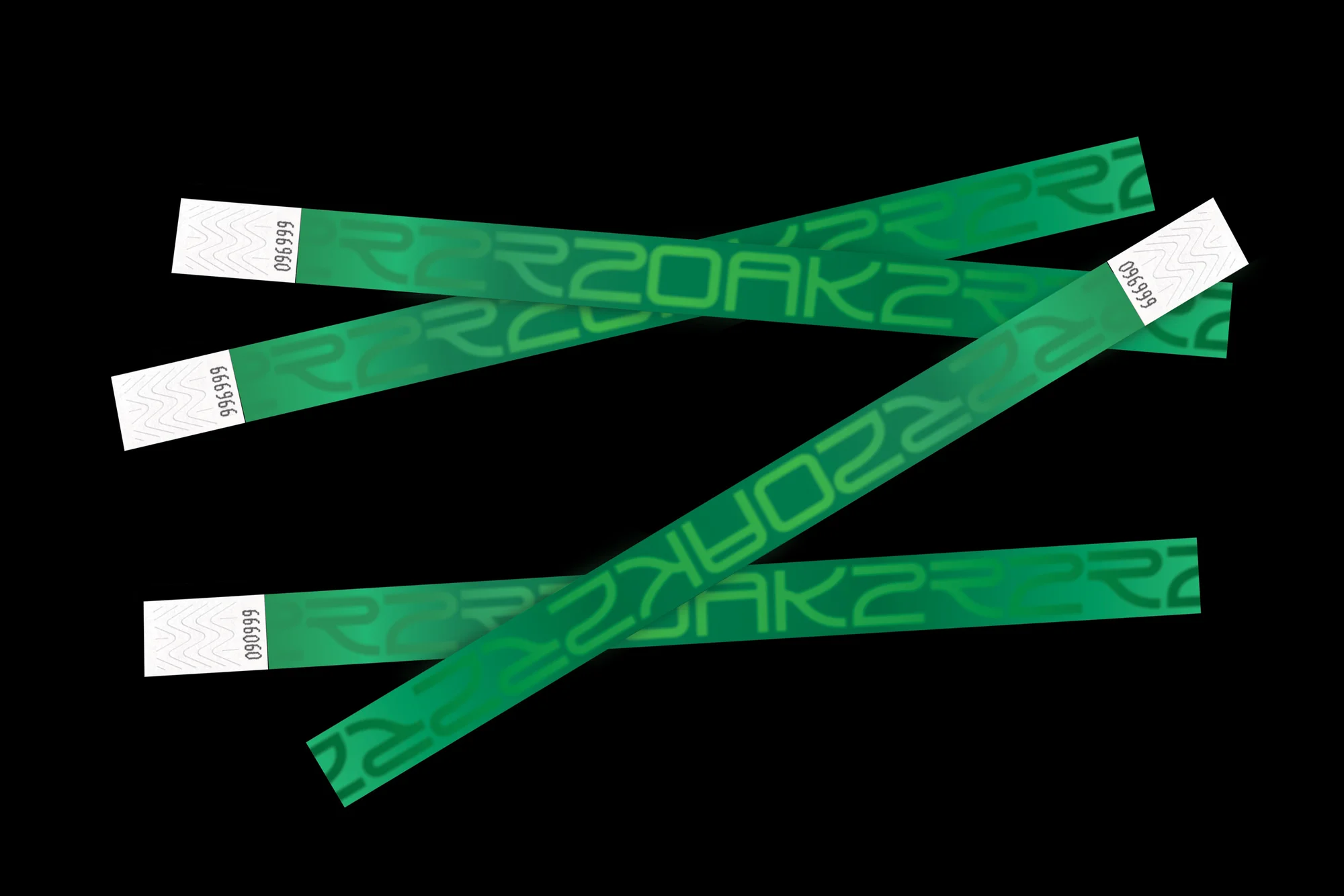 A cluster of green wristbands with white ends arranged on a black surface, creating a visually striking and graphic product shot.