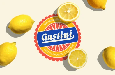 Gustini brand logo surrounded by whole and halved fresh yellow lemons on a pale cream background.