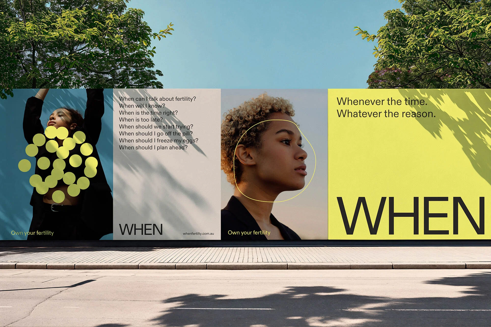 Eye-level shot of an outdoor billboard featuring two young women and text about fertility awareness against a clear blue sky background.