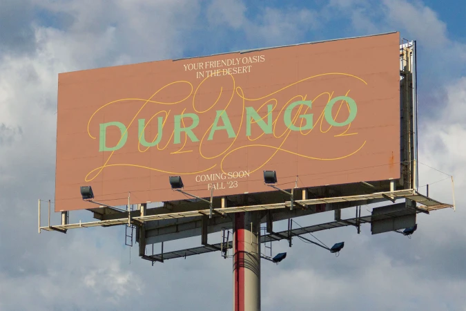Billboard with 'Durango' lettering against a blue, cloudy sky. Text says 'Your Friendly Oasis In The Desert, Coming Soon Fall '23'.