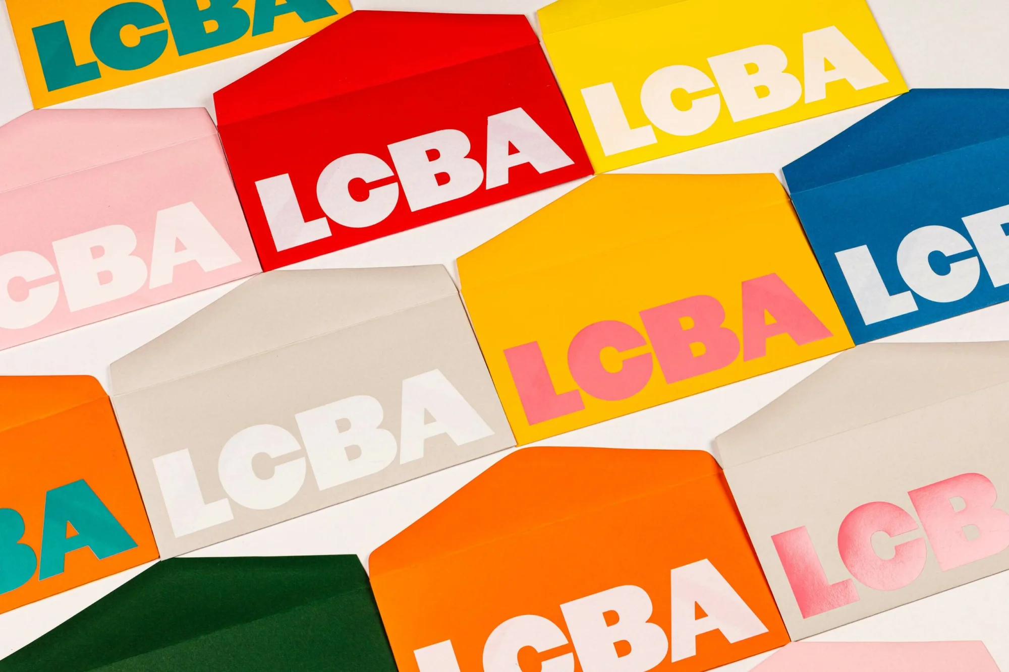 Colorful envelopes with white letters 'LCBA' arranged in a grid pattern against a white background, creating a vibrant, modern design.