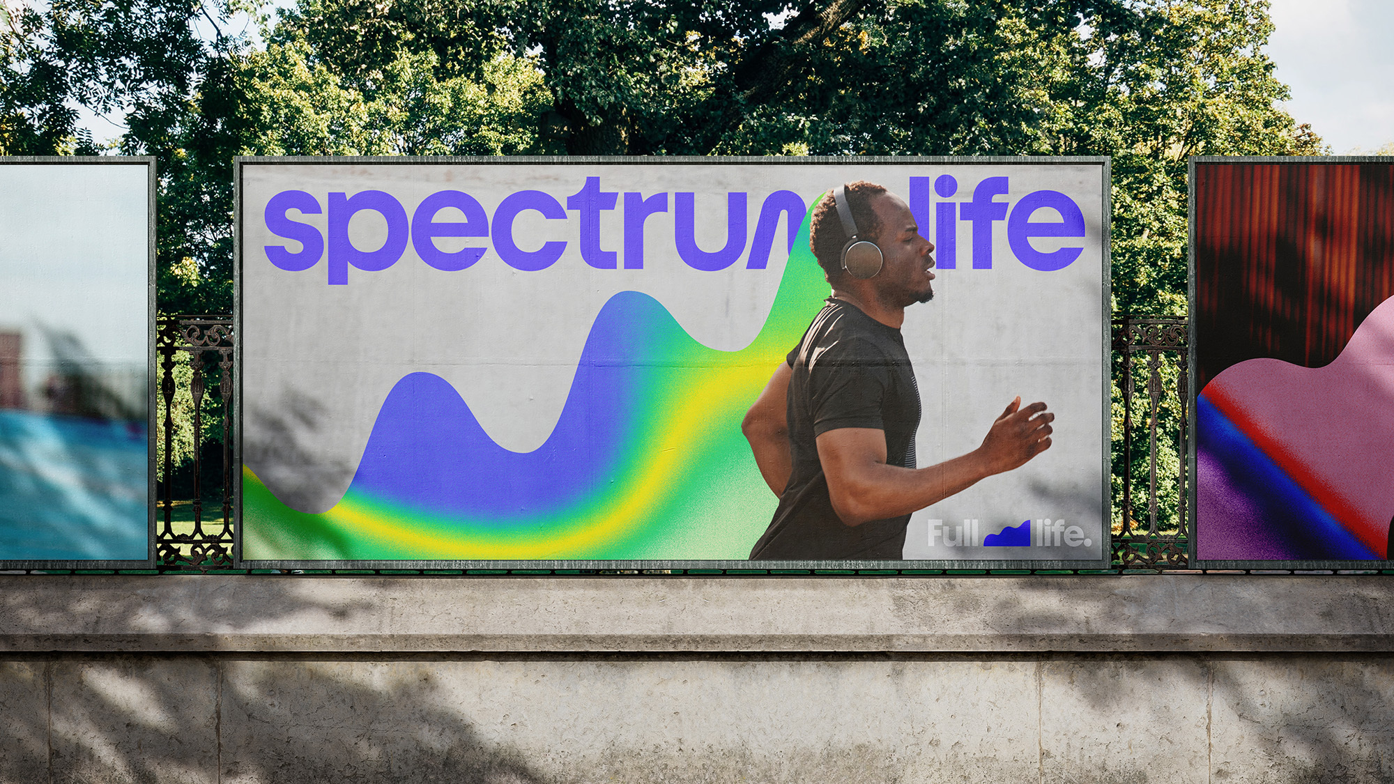 Outdoor billboard advertisement featuring a man jogging with headphones next to 'spectrum life' text and a wave graphic, surrounded by trees.