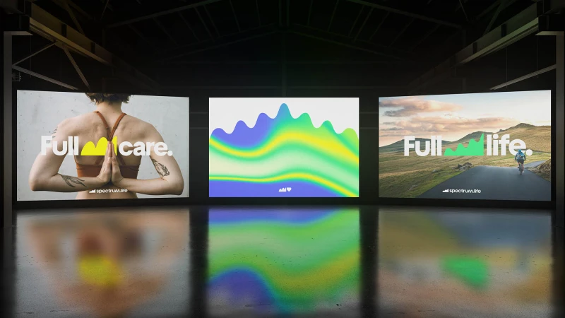 Three monitors display wellness and outdoor themes in a dark space, promoting a sense of health and vitality through visuals and minimalist text.