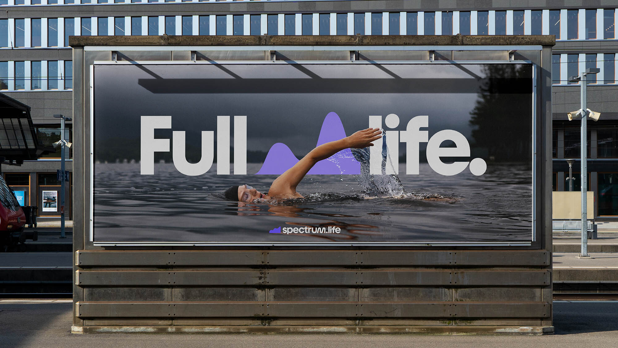 Billboard advertisement featuring a swimmer in water, promoting 'spectrum.life,' with the text 'Full life.' against an urban backdrop.