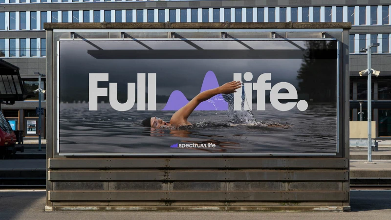 Billboard advertisement featuring a swimmer in water, promoting 'spectrum.life,' with the text 'Full life.' against an urban backdrop.