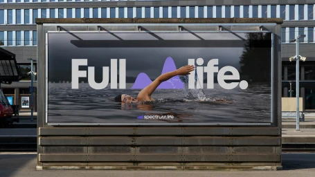 Outdoor billboard advertising Spectrum.Life featuring a swimmer in an outdoor lake with bold typography.