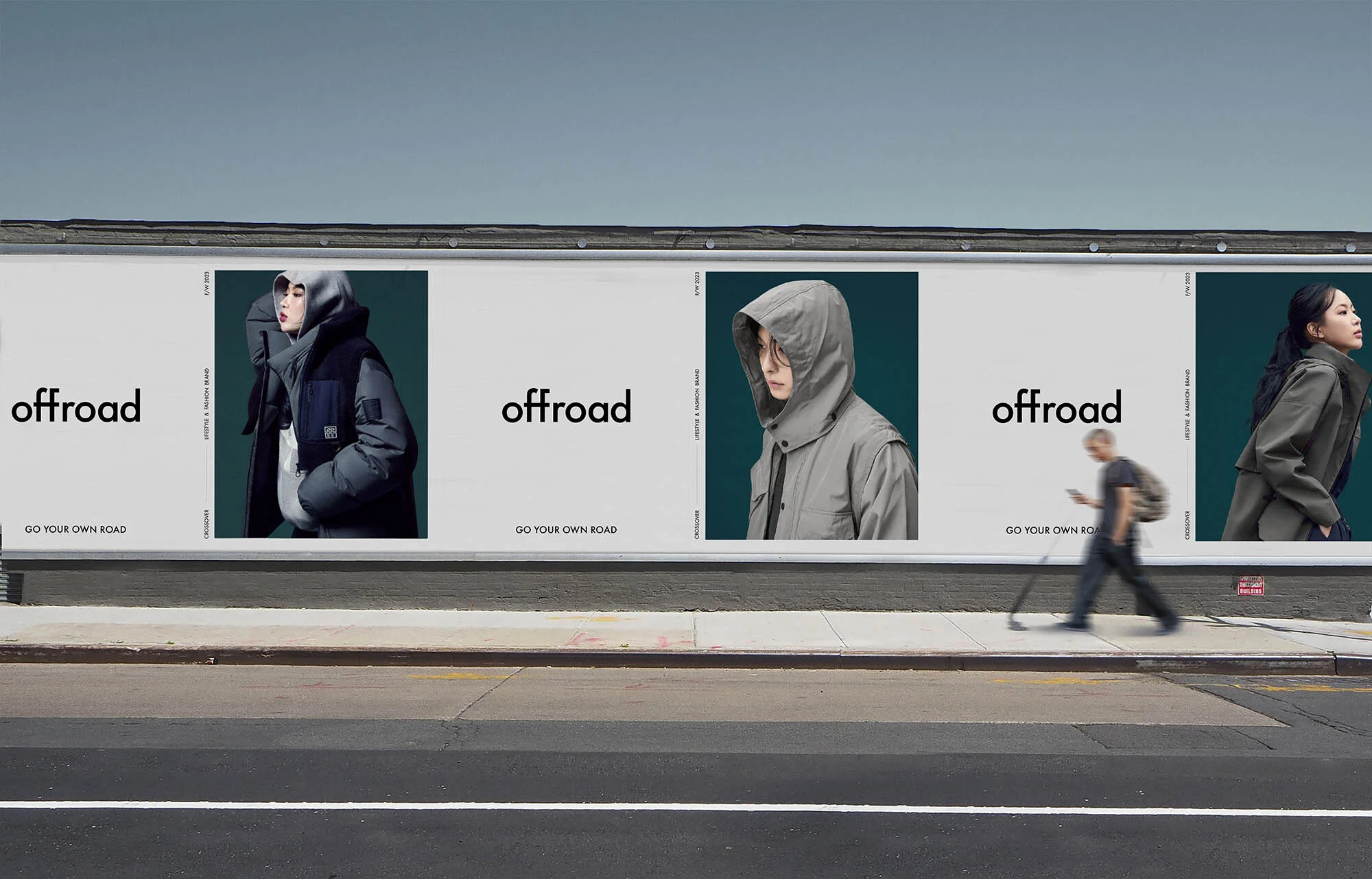 Outdoor billboard features three fashion models wearing jackets and coats, advertising the 'Offroad' brand, with a pedestrian passing.