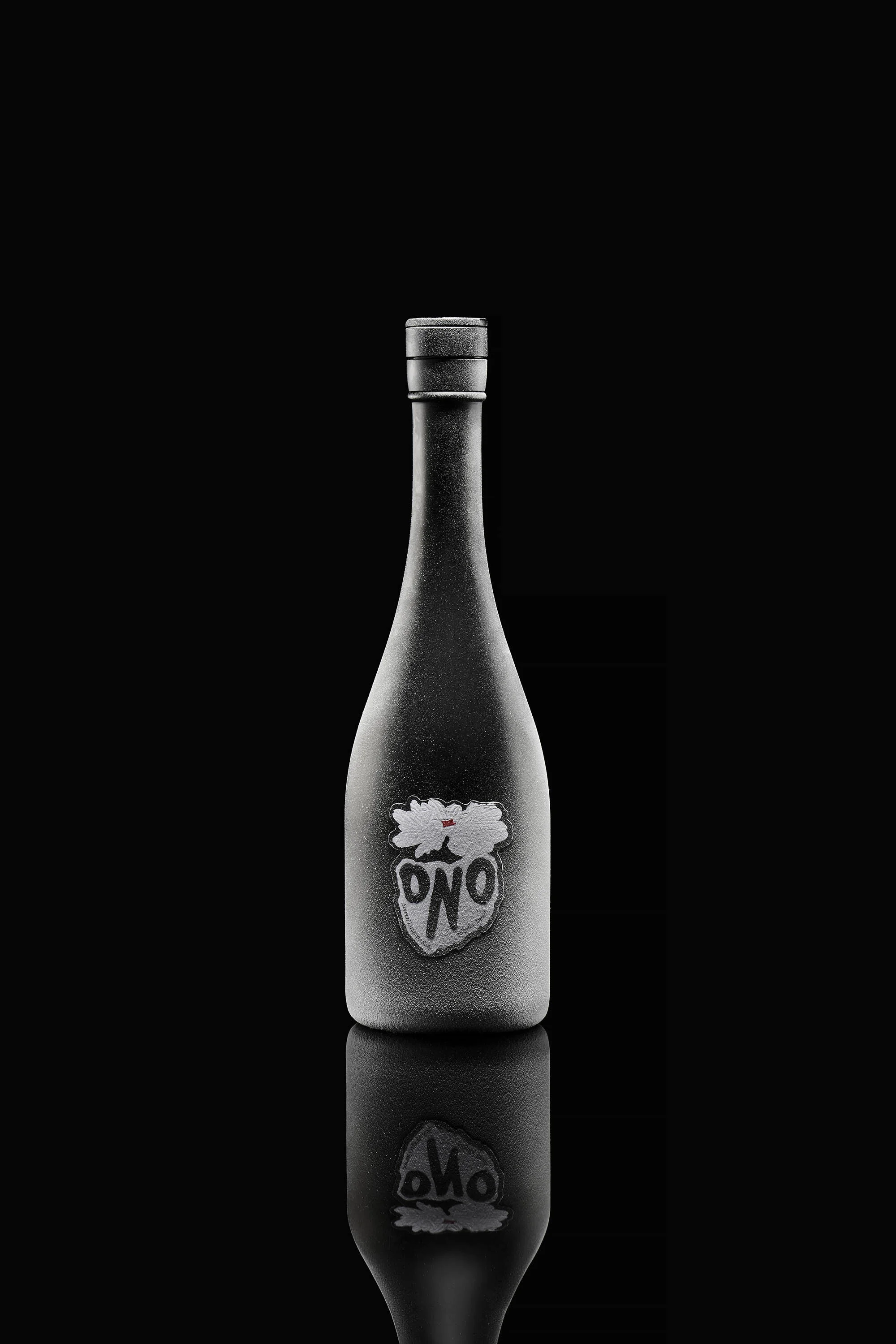 Dark-tone product shot of a wine bottle with a white label, mirrored reflection on a black surface.