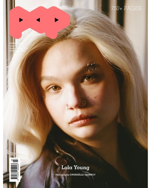 Magazine cover featuring a young adult with blonde hair, nose piercings, and a black leather jacket, framed against a neutral background.