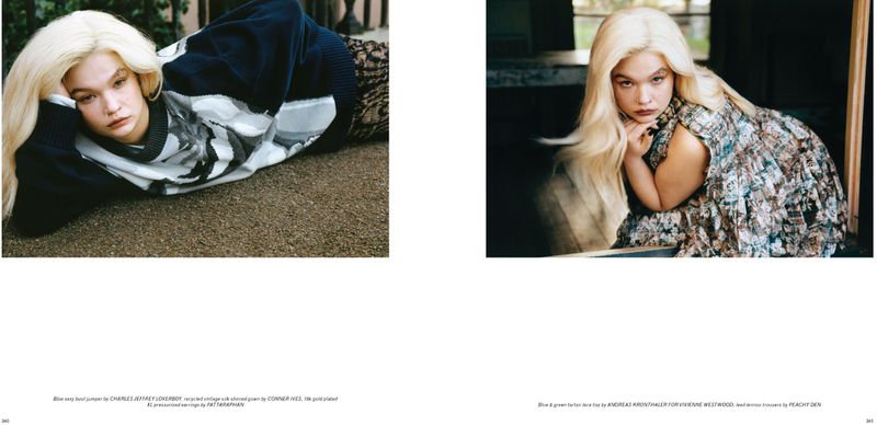 Young woman with platinum blonde hair poses in a studio wearing a patterned dress and black jumper. Fashion editorial shot.